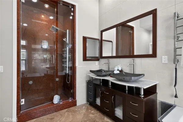 a bathroom with a sink a light fixture and a mirror