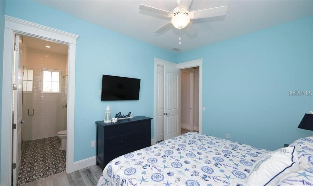 212 Spring Avenue Anna Maria, FL 34216 - Photo 15 of 31 a bedroom with a bed and a flat screen tv