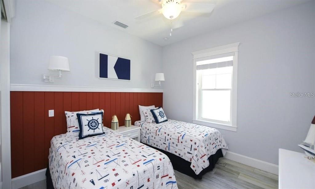 212 Spring Avenue Anna Maria, FL 34216 - Photo 17 of 31 a bedroom with two beds and a window