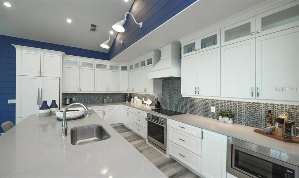 212 Spring Avenue Anna Maria, FL 34216 - Photo 2 of 31 a kitchen with a sink cabinets and window