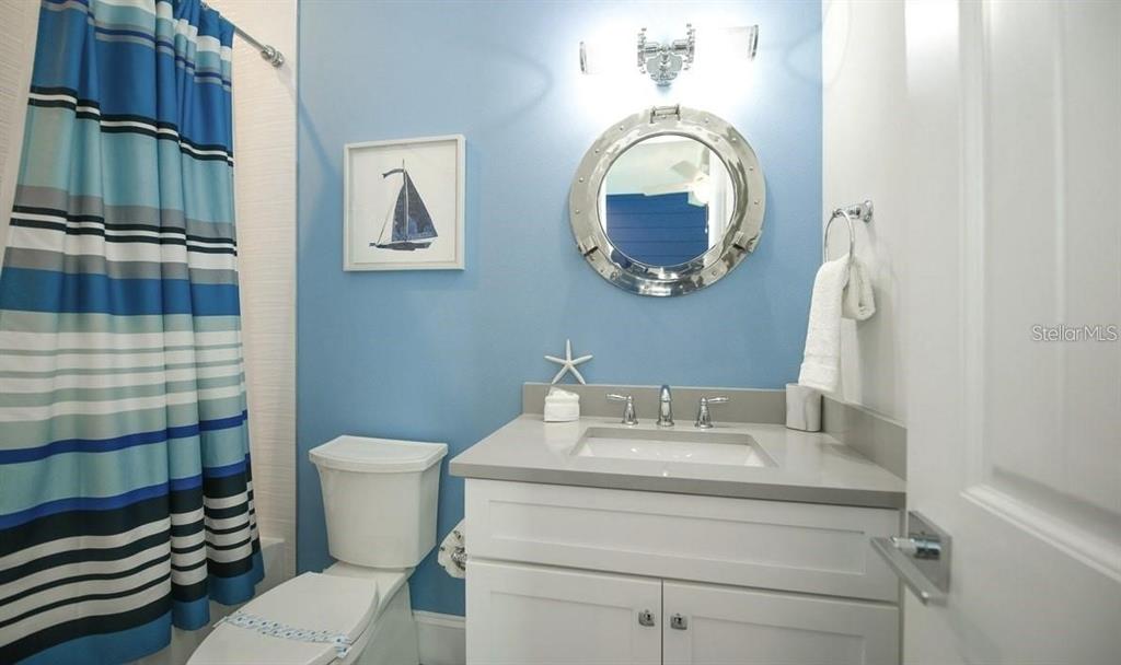 212 Spring Avenue Anna Maria, FL 34216 - Photo 23 of 31 a bathroom with a toilet a sink and a mirror
