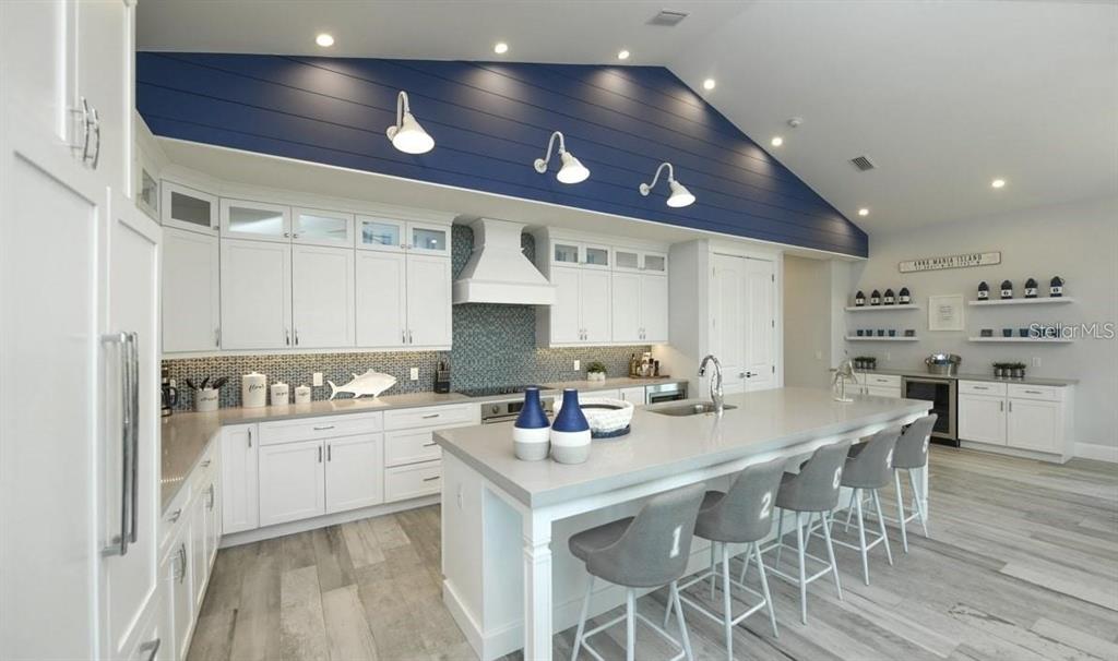 212 Spring Avenue Anna Maria, FL 34216 - Photo 4 of 31 a kitchen with a cabinets a sink stainless steel appliances and cabinets