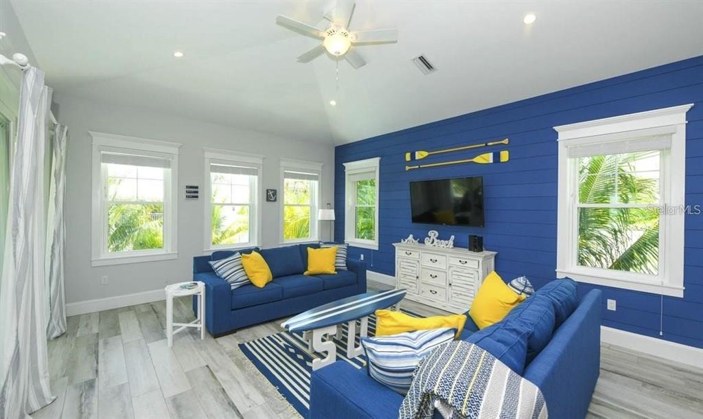 212 Spring Avenue Anna Maria, FL 34216 - Photo 7 of 31 a living room with furniture fireplace and a large window