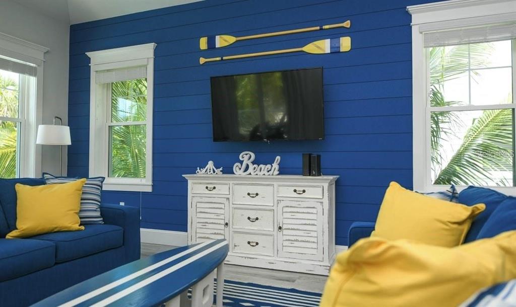 212 Spring Avenue Anna Maria, FL 34216 - Photo 8 of 31 a living room with furniture and a flat screen tv
