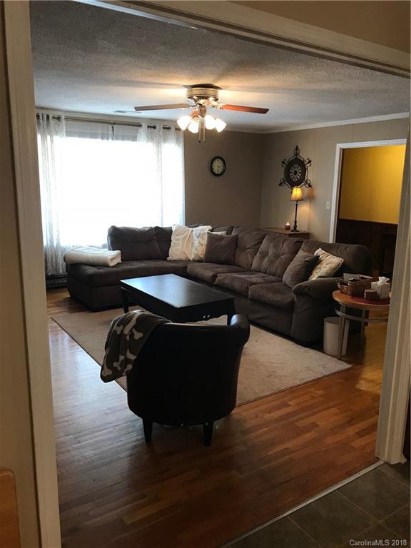628 Loray Farm Road Dallas, NC 28034 - Photo 12 of 35 a living room with furniture and a flat screen tv