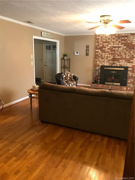 628 Loray Farm Road Dallas, NC 28034 - Photo 14 of 35 a living room with furniture and a fireplace