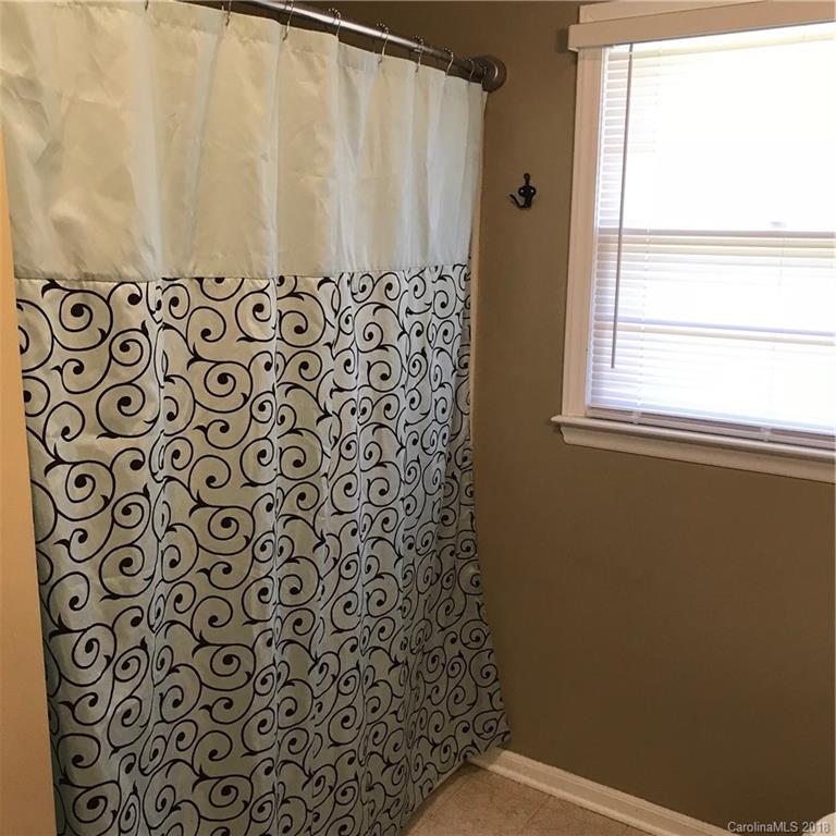 628 Loray Farm Road Dallas, NC 28034 - Photo 17 of 35 a bathroom with a shower curtain and a window