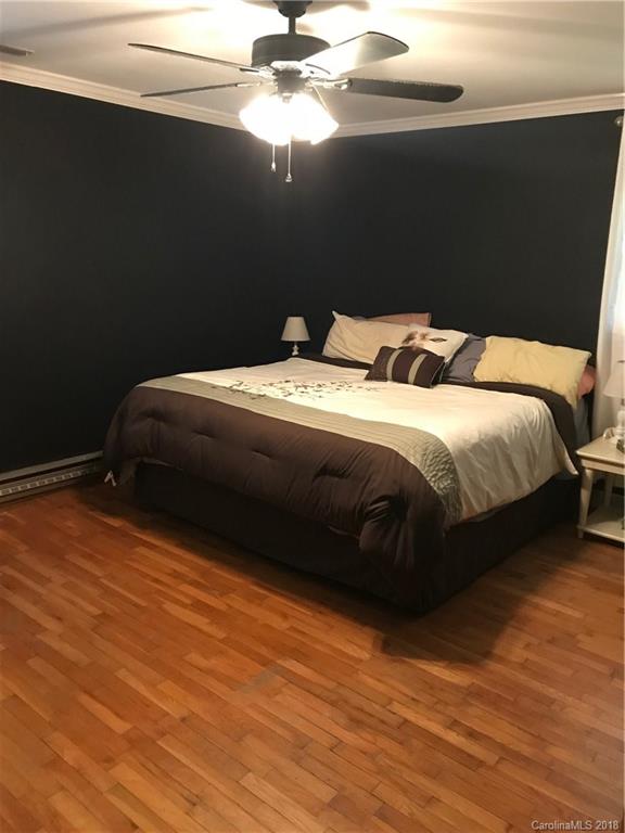 628 Loray Farm Road Dallas, NC 28034 - Photo 18 of 35 a bedroom with a bed and a ceiling fan