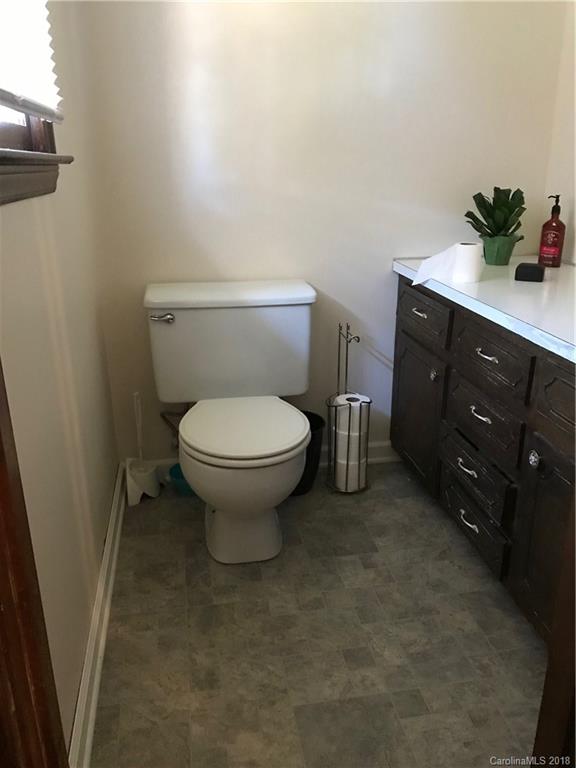 628 Loray Farm Road Dallas, NC 28034 - Photo 21 of 35 a bathroom with a granite countertop toilet and a sink
