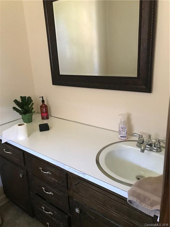 628 Loray Farm Road Dallas, NC 28034 - Photo 22 of 35 a bathroom with a sink and a mirror