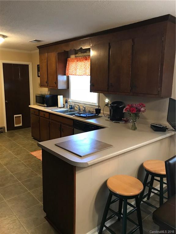 628 Loray Farm Road Dallas, NC 28034 - Photo 8 of 35 a kitchen with a sink cabinets and wooden floor