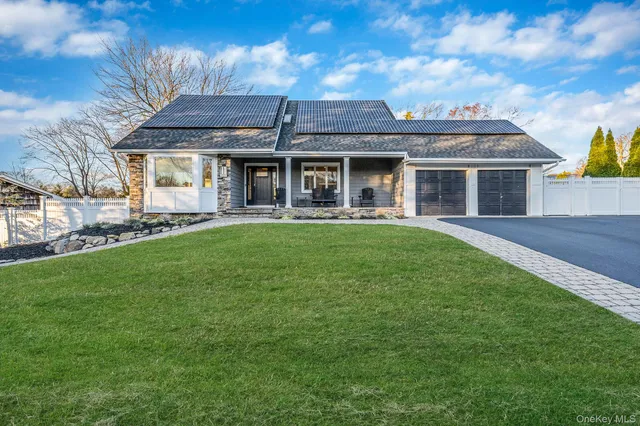 a front view of a house with a garden and yard