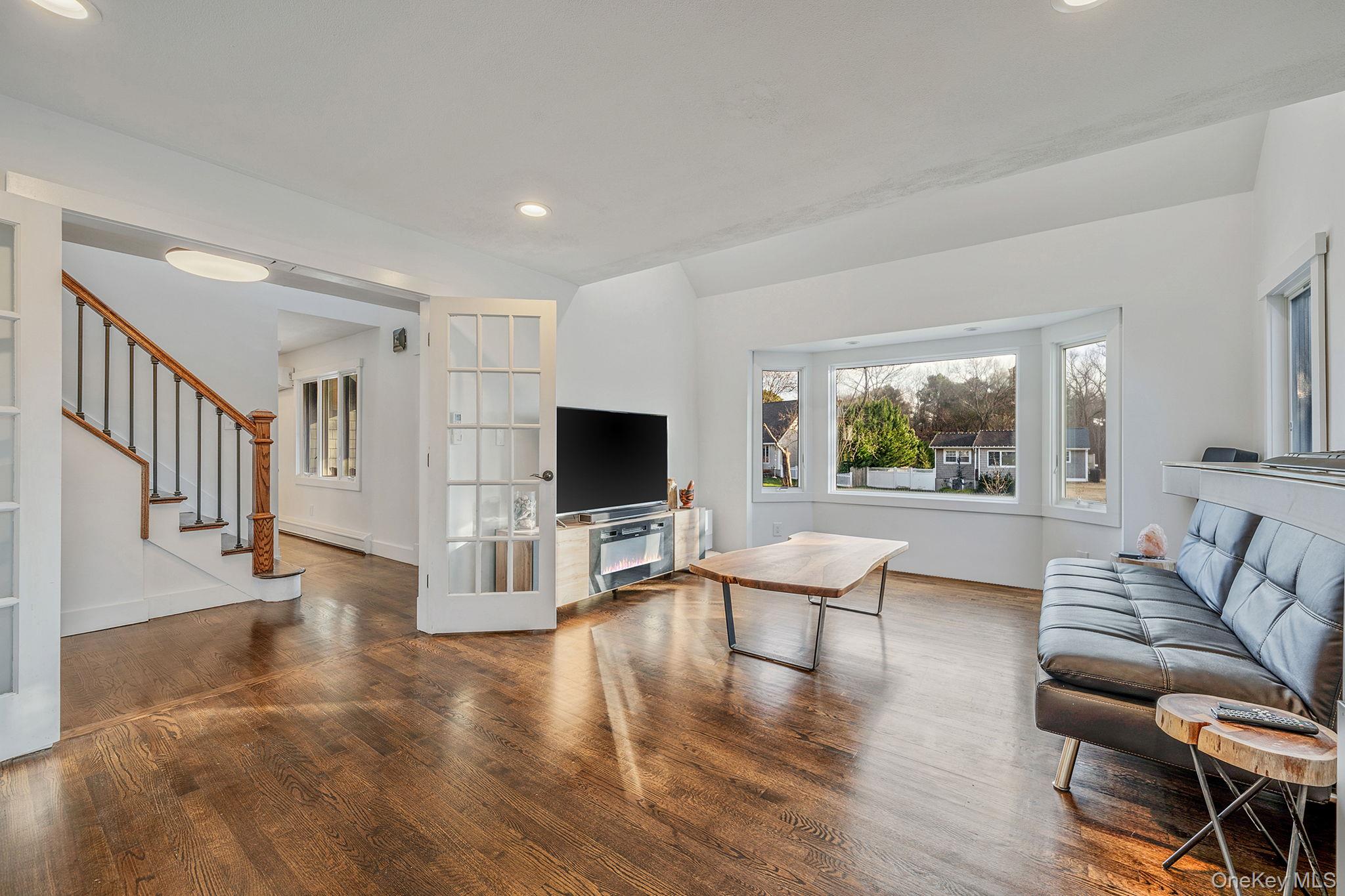 11 Chivalry Lane Nesconset, NY 11767 - Photo 15 of 35 a living room with furniture a flat screen tv and wooden floor