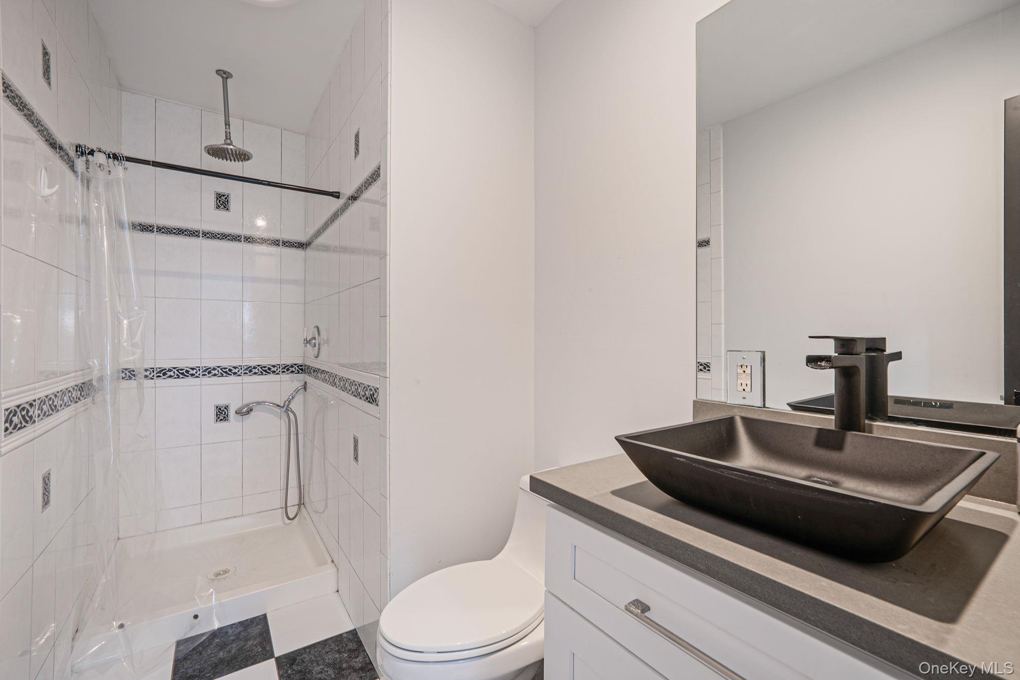 11 Chivalry Lane Nesconset, NY 11767 - Photo 16 of 35 a bathroom with a sink a toilet a mirror and shower