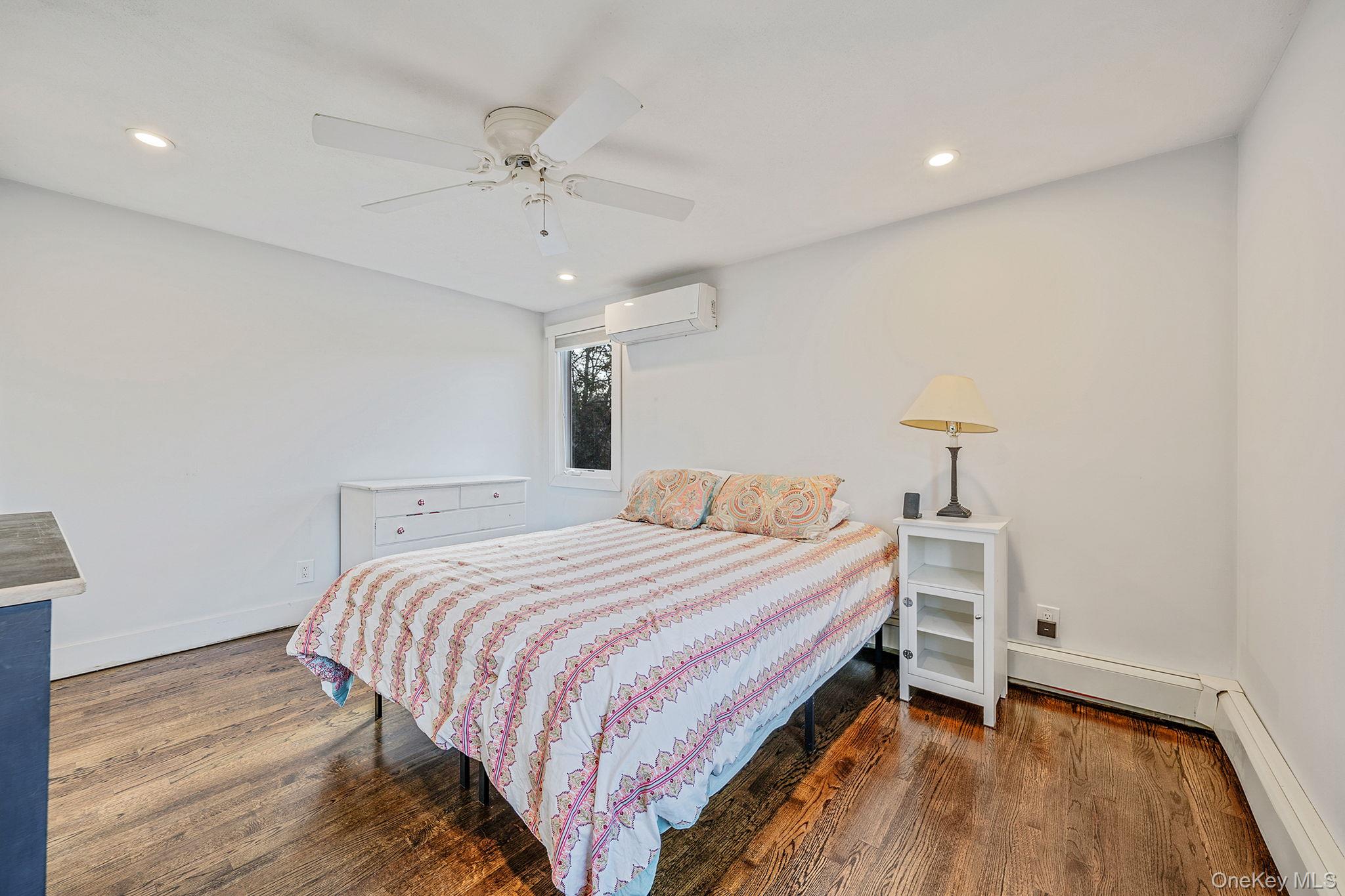 11 Chivalry Lane Nesconset, NY 11767 - Photo 18 of 35 a bedroom with a bed and a chandelier