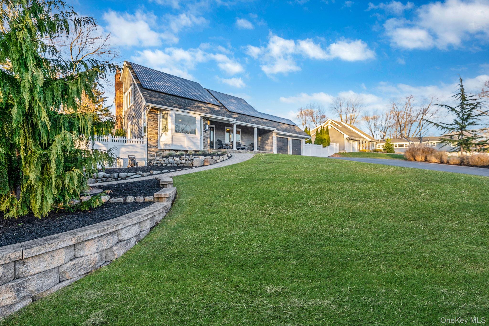 11 Chivalry Lane Nesconset, NY 11767 - Photo 2 of 35 a front view of a house with a yard