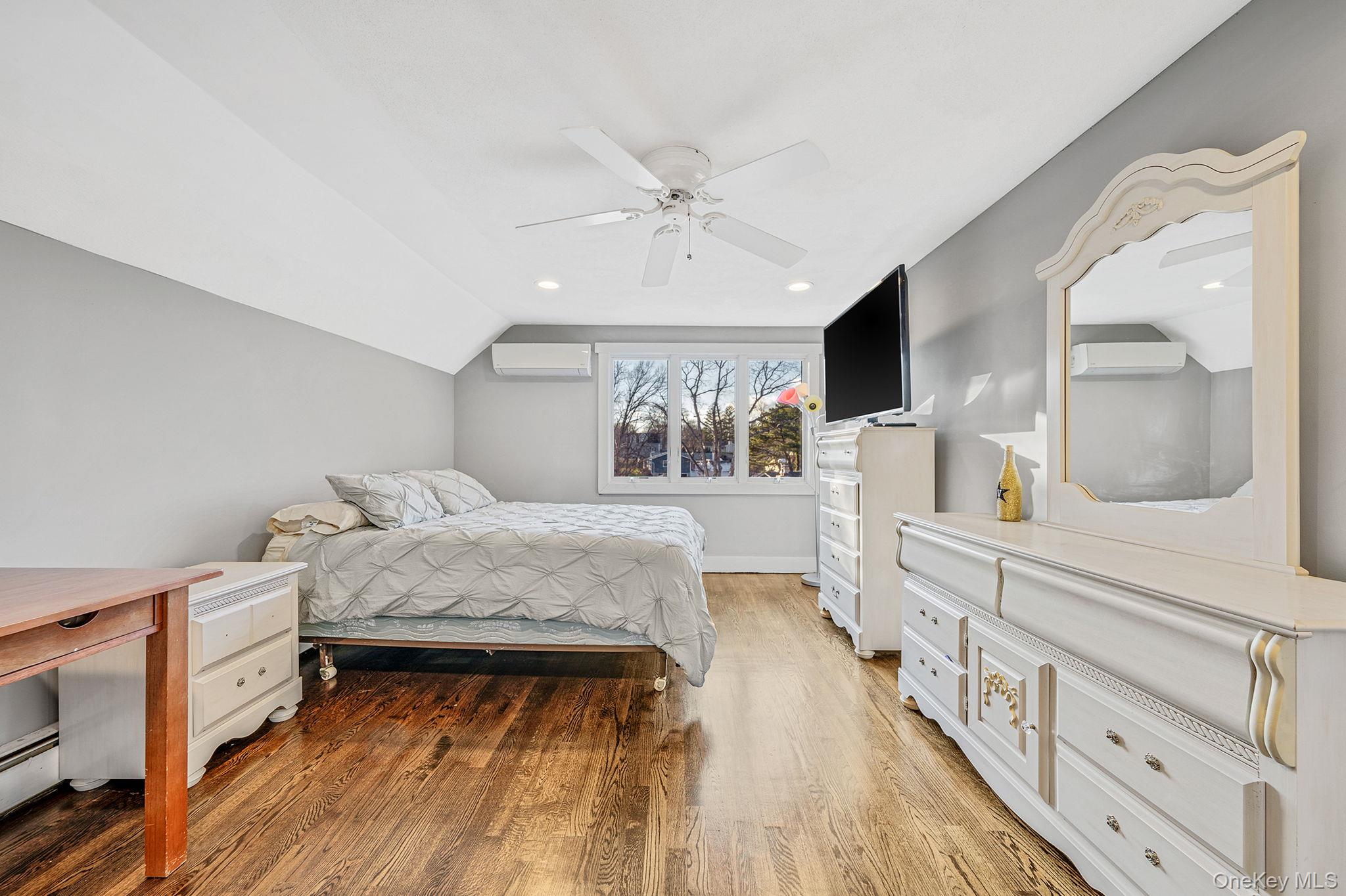 11 Chivalry Lane Nesconset, NY 11767 - Photo 22 of 35 a living room with a bed furniture flat screen tv and a large window