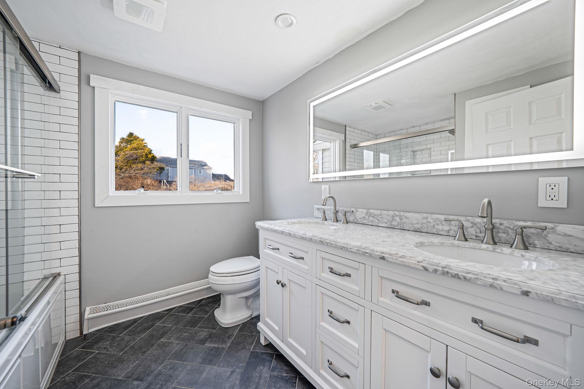 11 Chivalry Lane Nesconset, NY 11767 - Photo 23 of 35 a bathroom with a granite countertop toilet sink and mirror