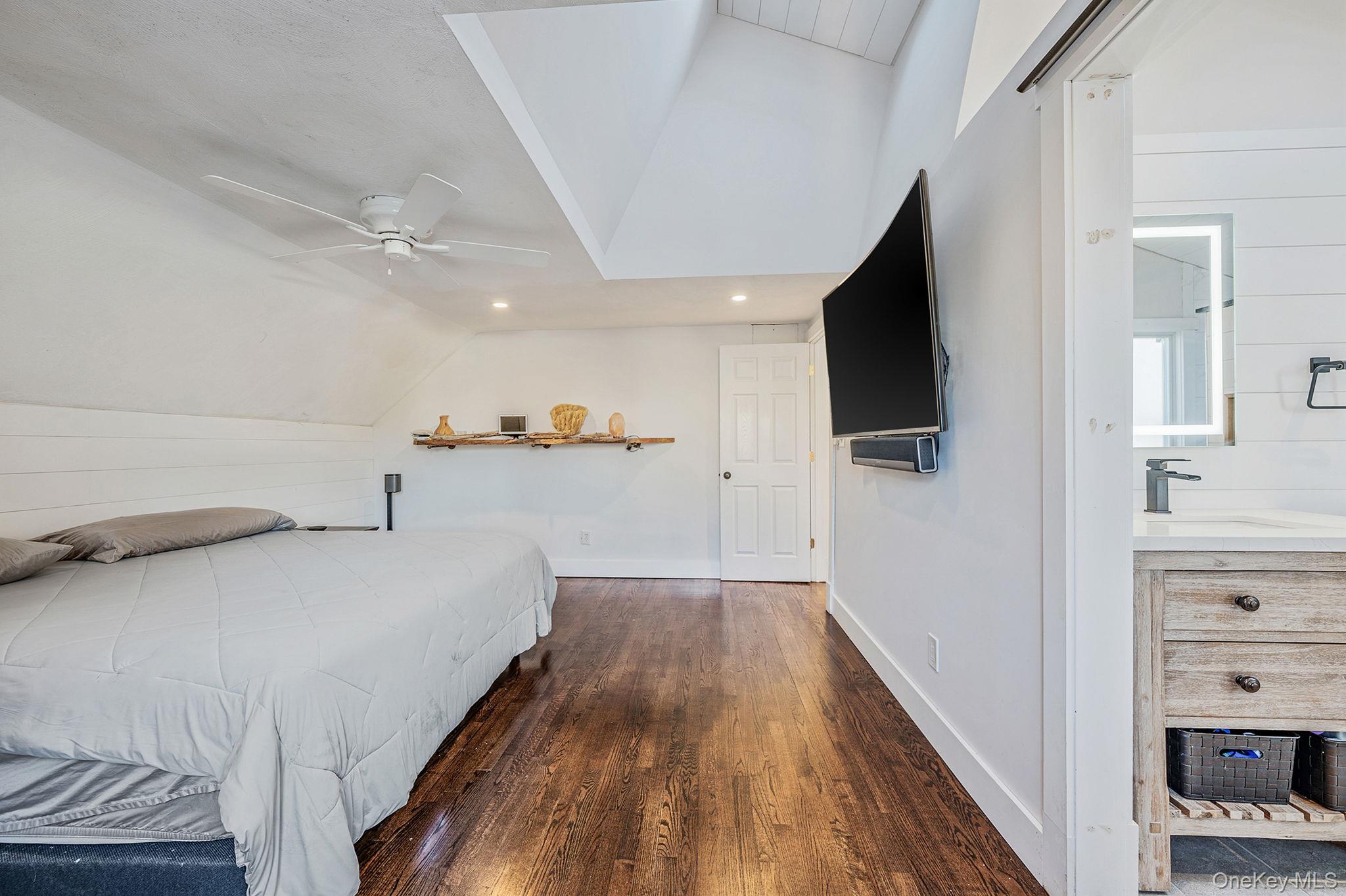 11 Chivalry Lane Nesconset, NY 11767 - Photo 25 of 35 a view of a livingroom with wooden floor and a flat screen tv