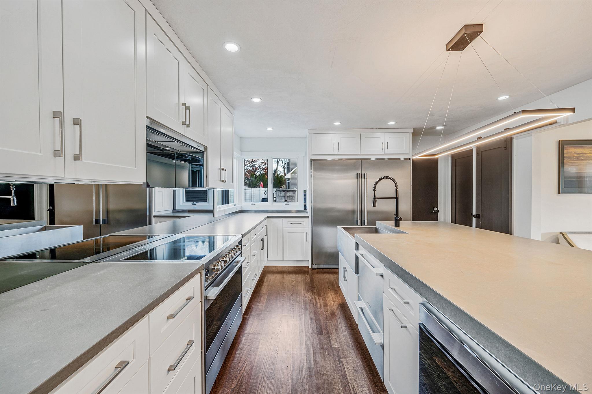 11 Chivalry Lane Nesconset, NY 11767 - Photo 5 of 35 a large kitchen with stainless steel appliances lots of counter space and wooden floor