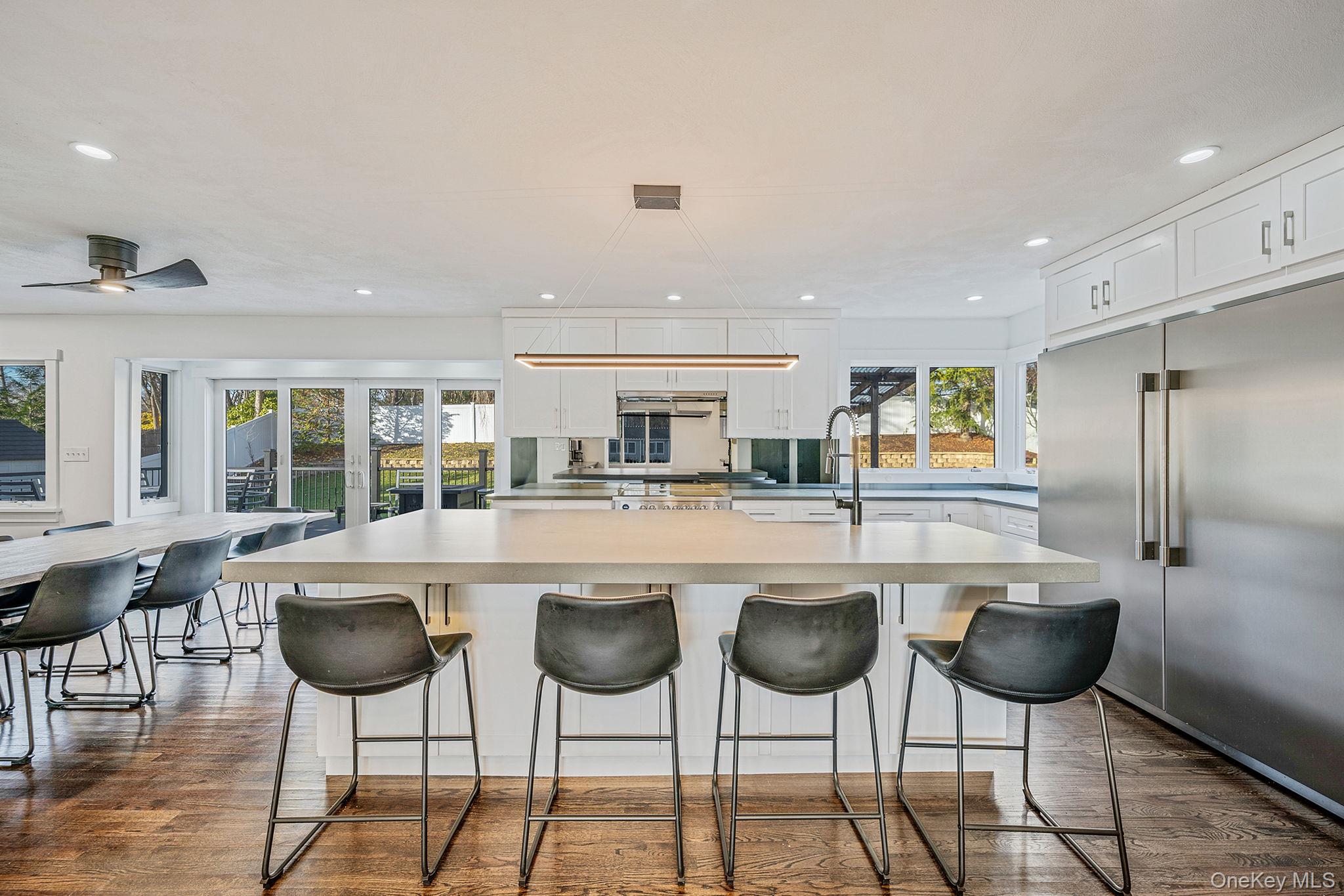 11 Chivalry Lane Nesconset, NY 11767 - Photo 9 of 35 a kitchen with stainless steel appliances kitchen island granite countertop a table and chairs