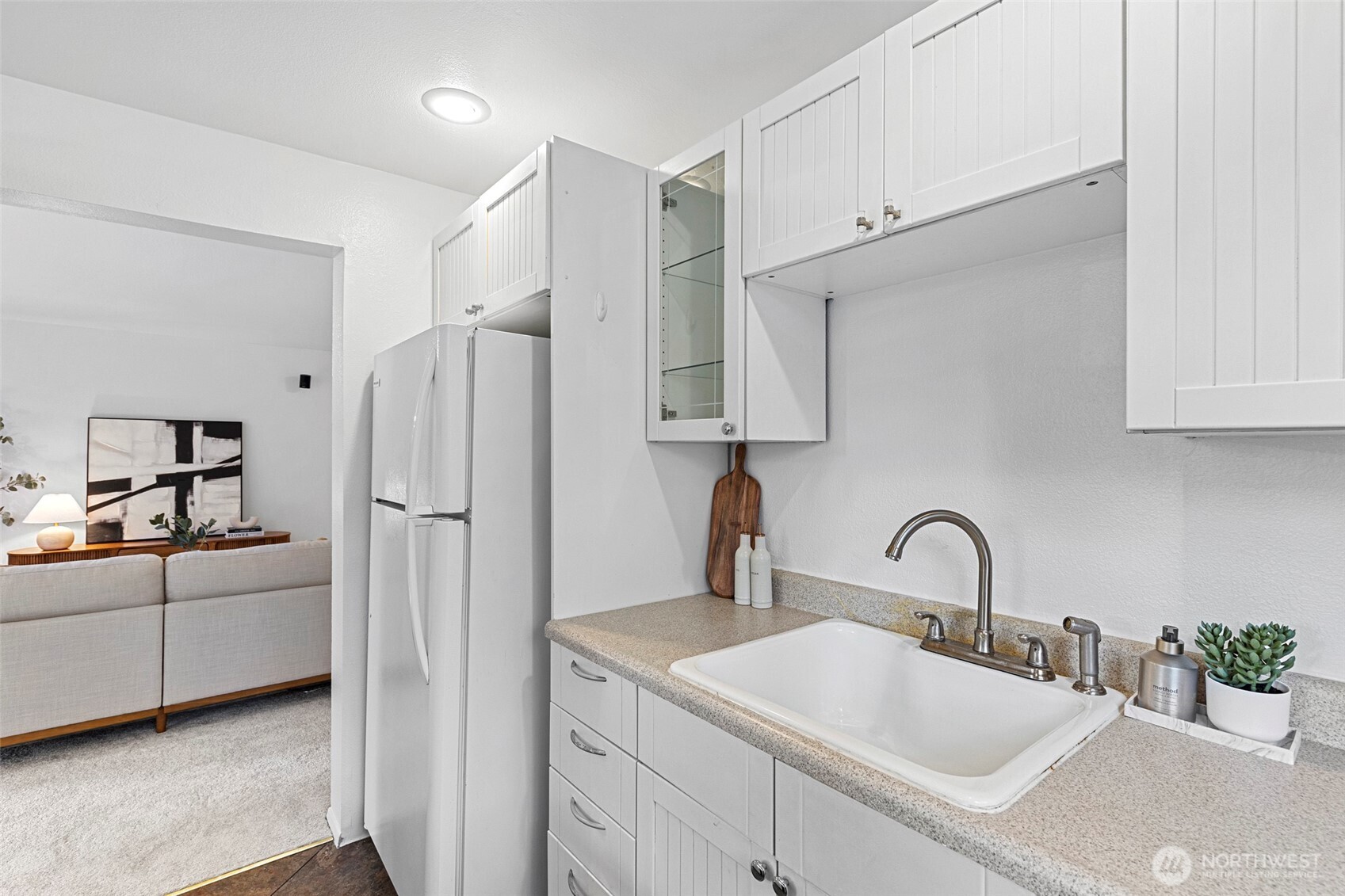 13801 Old Redmond Road, Unit A101 Redmond, WA 98052 - Photo 18 of 37 a kitchen with stainless steel appliances a sink a refrigerator and cabinets