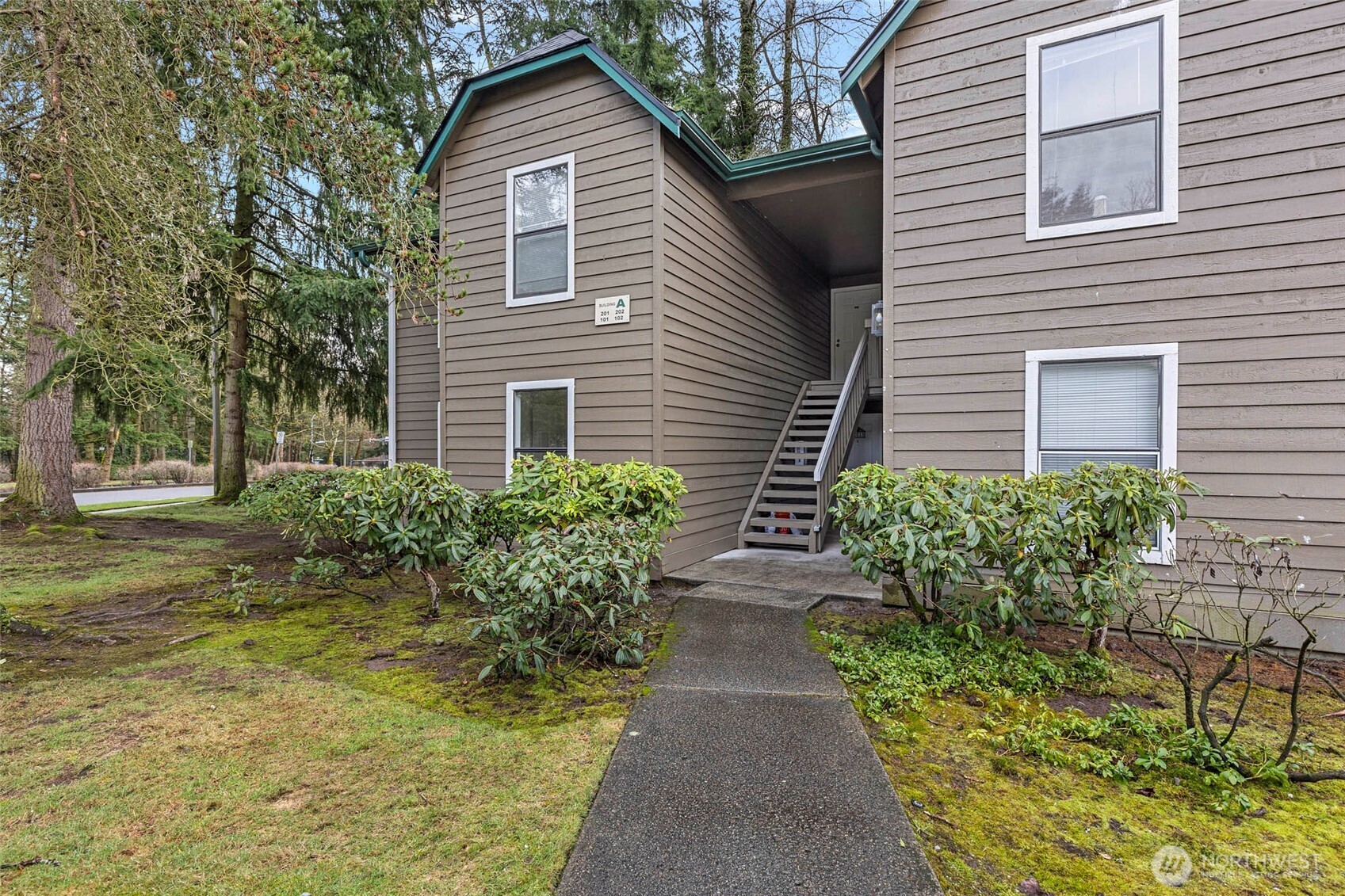 13801 Old Redmond Road, Unit A101 Redmond, WA 98052 - Photo 3 of 37 a view of a house with potted plants and a large tree
