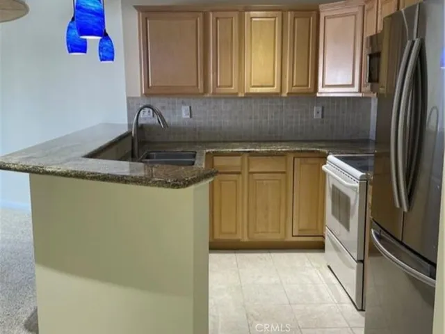 a kitchen with a sink stove and refrigerator