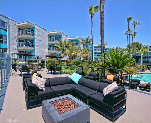 a view of a patio with couches and a potted plant on the table