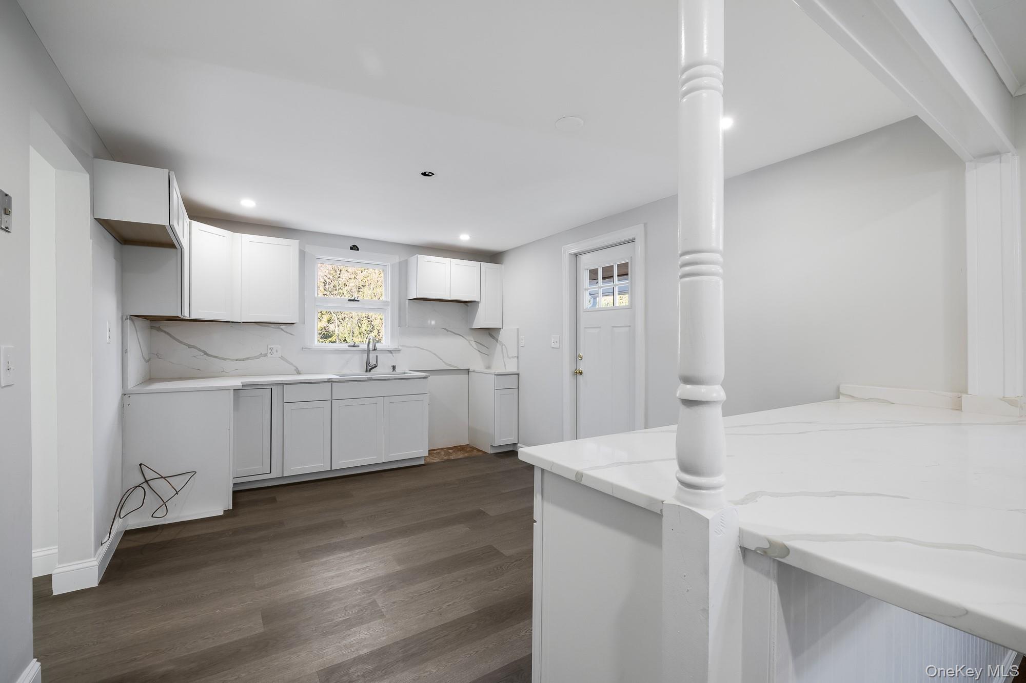 122 Rosman Road Thiells, NY 10984 - Photo 11 of 30 a kitchen with white cabinets and white appliances