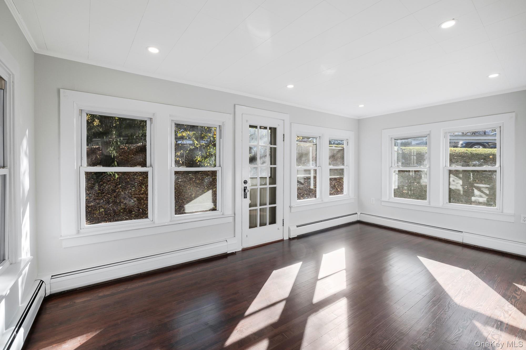 122 Rosman Road Thiells, NY 10984 - Photo 21 of 30 a view of an empty room with a window and wooden floor
