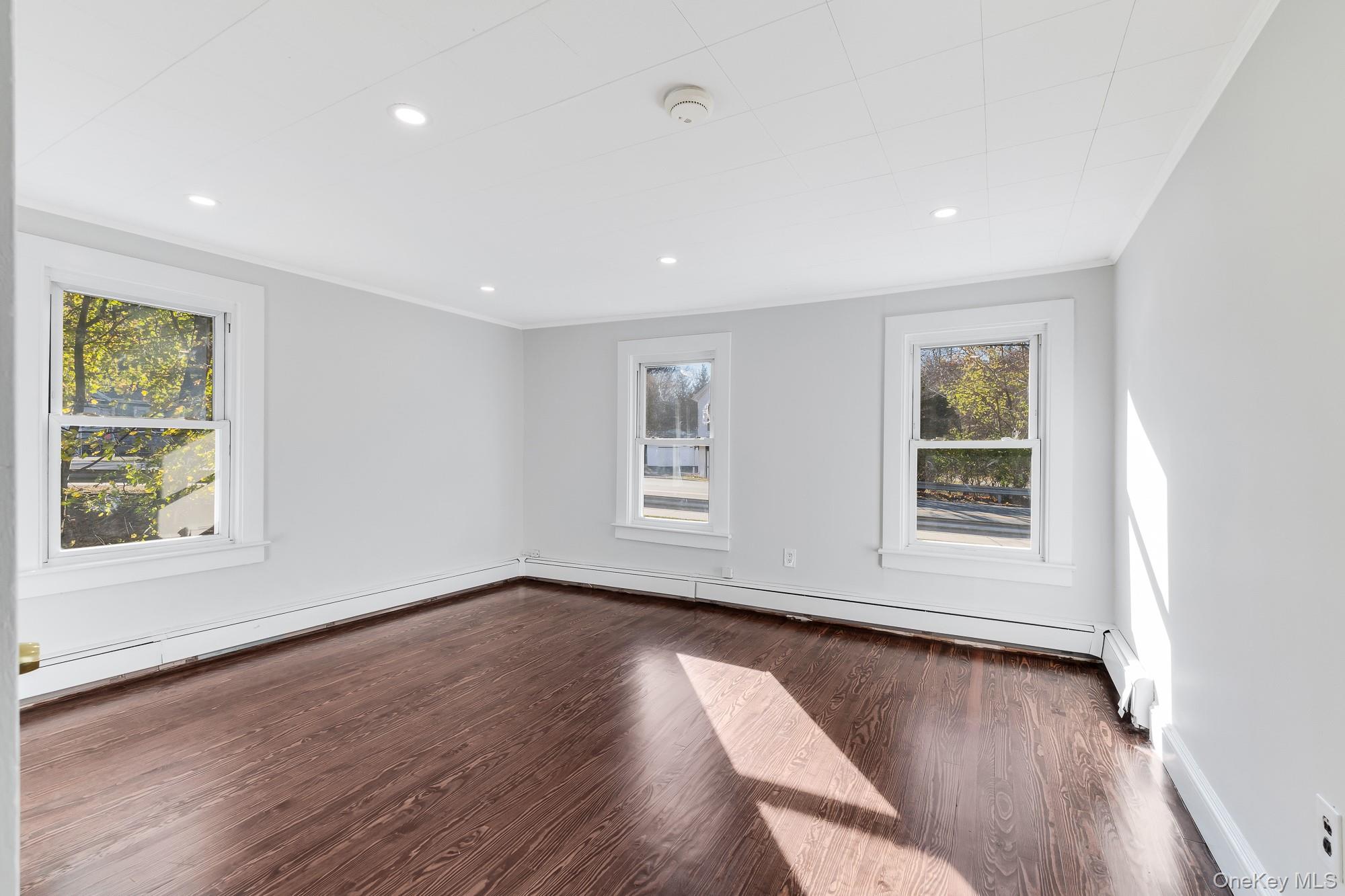 122 Rosman Road Thiells, NY 10984 - Photo 4 of 30 a view of an empty room with wooden floor and a window