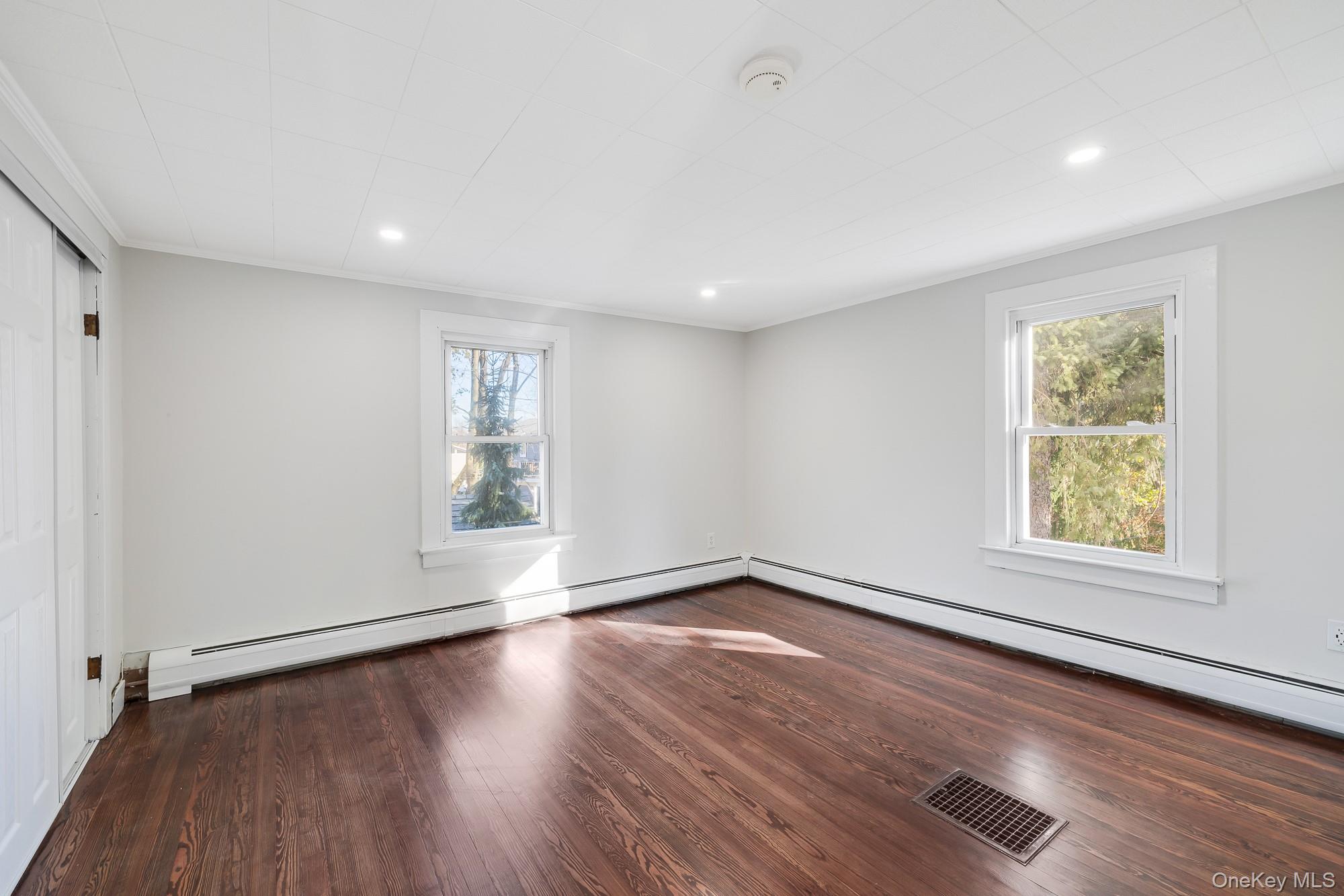 122 Rosman Road Thiells, NY 10984 - Photo 5 of 30 an empty room with wooden floor and windows