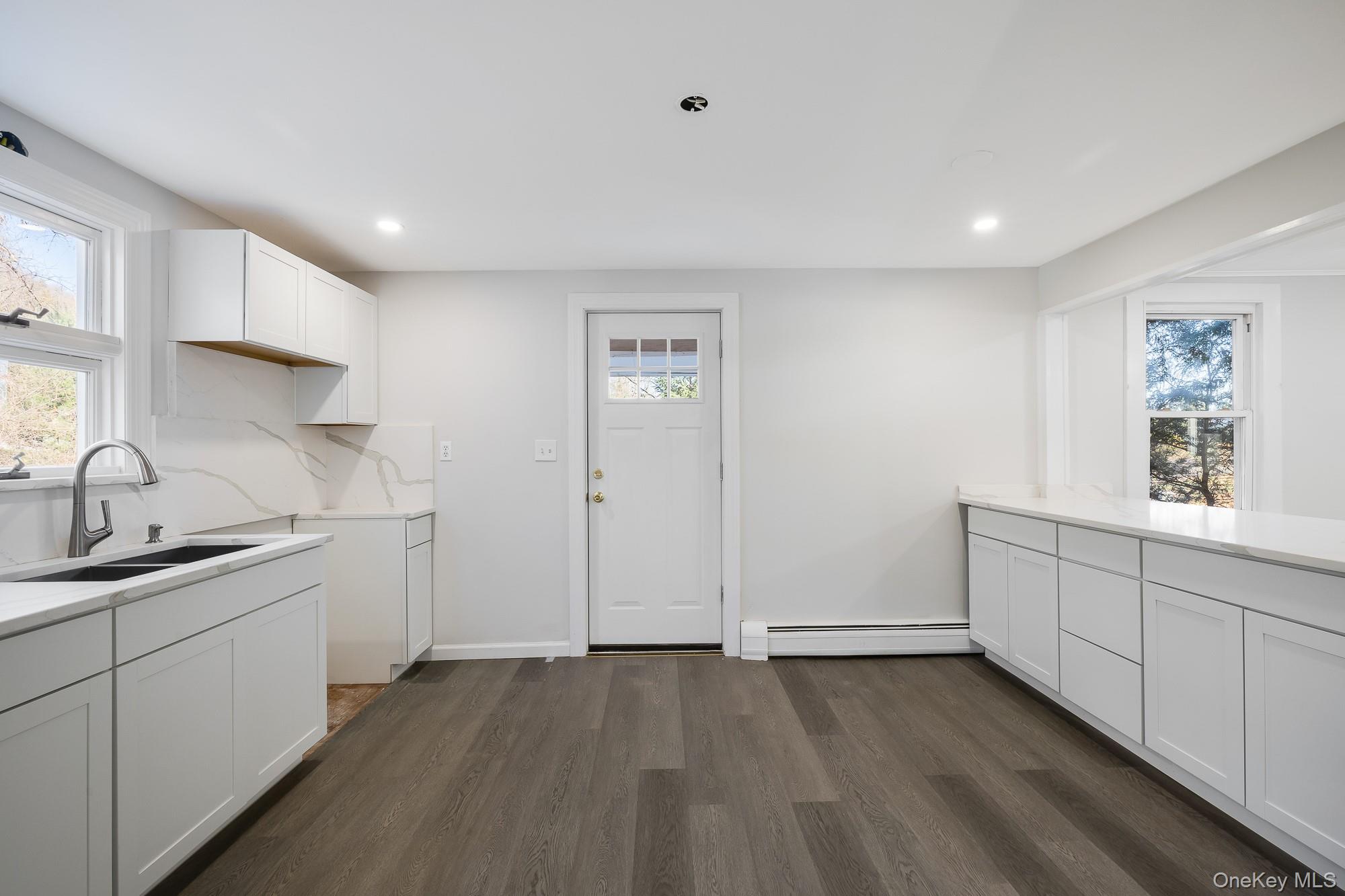 122 Rosman Road Thiells, NY 10984 - Photo 10 of 30 a kitchen with a sink cabinets and wooden floor