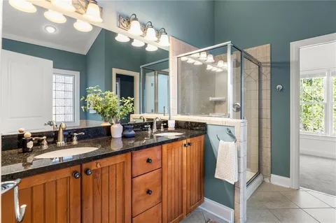 a bathroom with a sink double vanity and a mirror