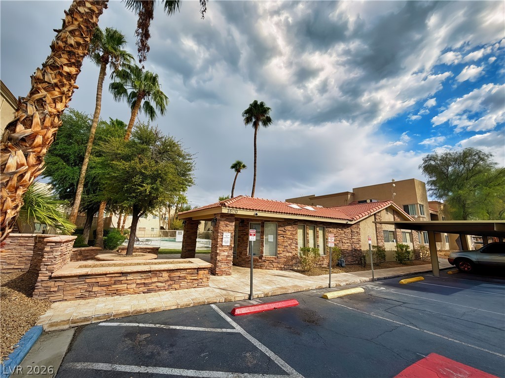 1852 North Decatur Boulevard, Unit 101 Las Vegas, NV 89108 - Photo 22 of 45 A stone veneer exterior accents this community building nestled under mature palm trees.