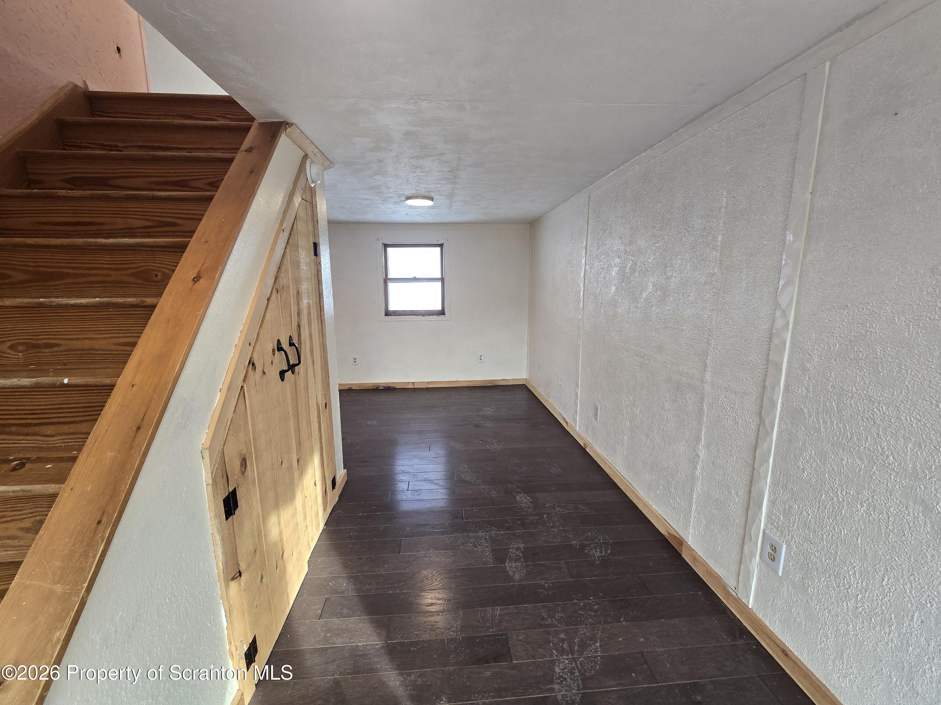 483 Turnpike Street Susquehanna, PA 18847 - Photo 25 of 27 a view of a hallway with wooden floor and staircase