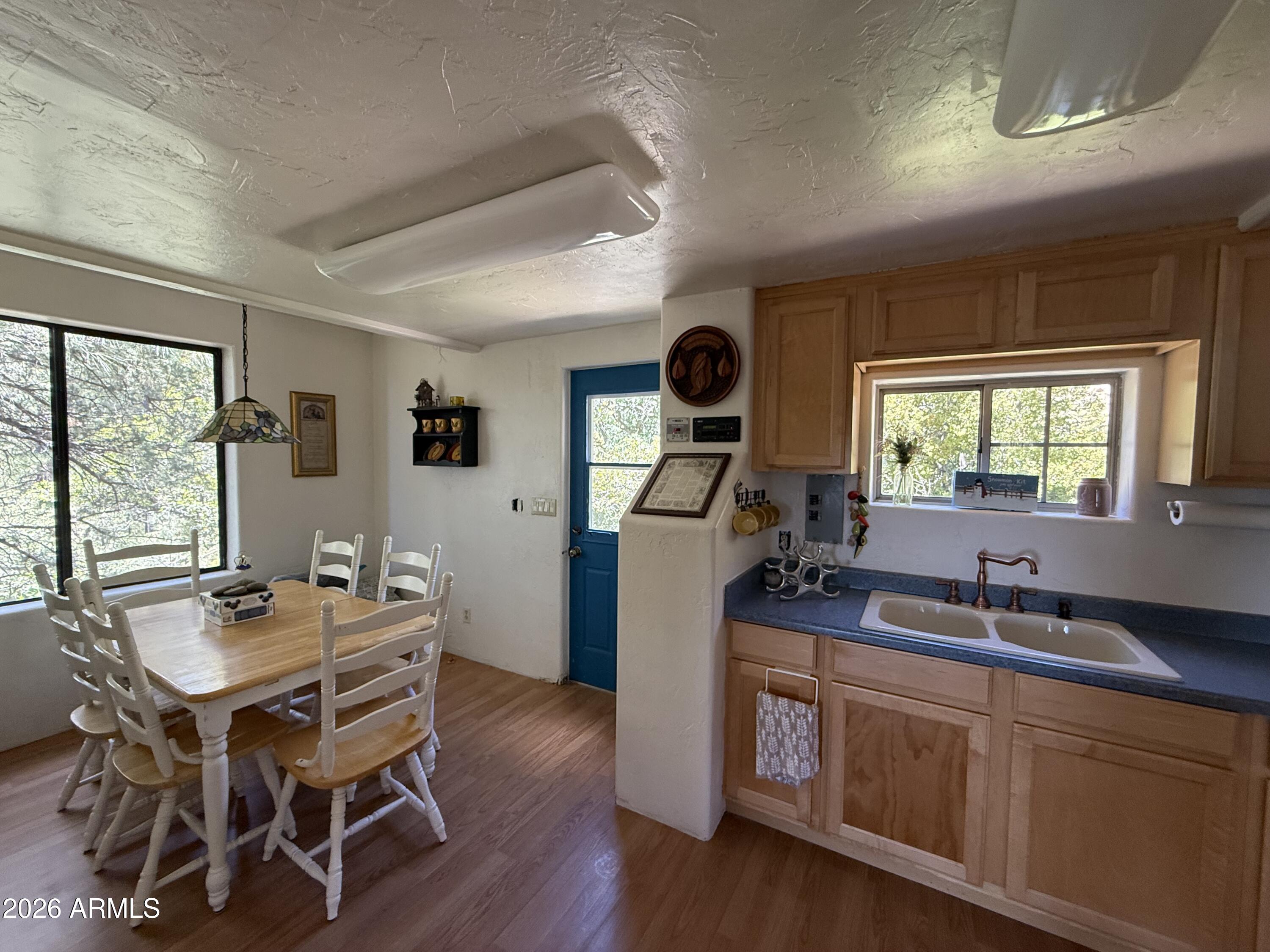 22406 South Eagle Mine Road Crown King, AZ 86343 - Photo 5 of 20 a view of a dining room with furniture window and wooden floor