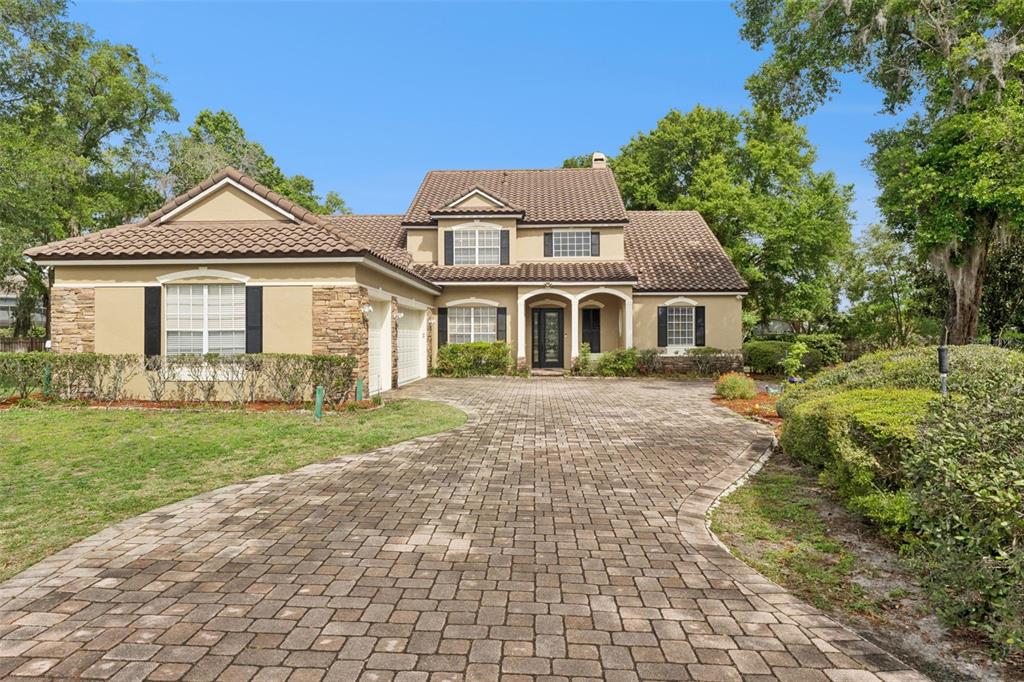 216 Juniper Ridge Court Sanford, FL 32771 - Photo 2 of 61 a view of a yard in front of a house with large windows