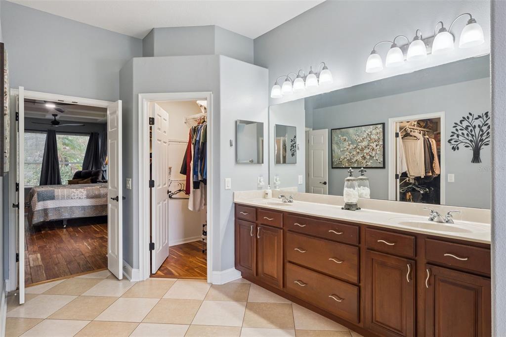 216 Juniper Ridge Court Sanford, FL 32771 - Photo 23 of 61 a spacious en suite bathroom with a double vanity sink and a mirror