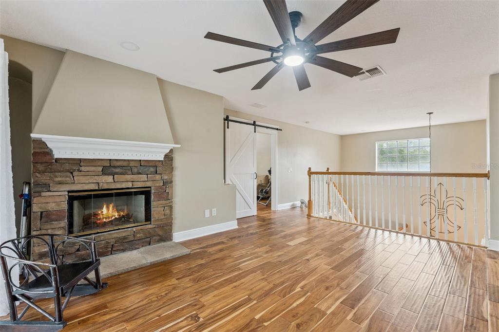 216 Juniper Ridge Court Sanford, FL 32771 - Photo 35 of 61 a living room with wooden floor and a fireplace