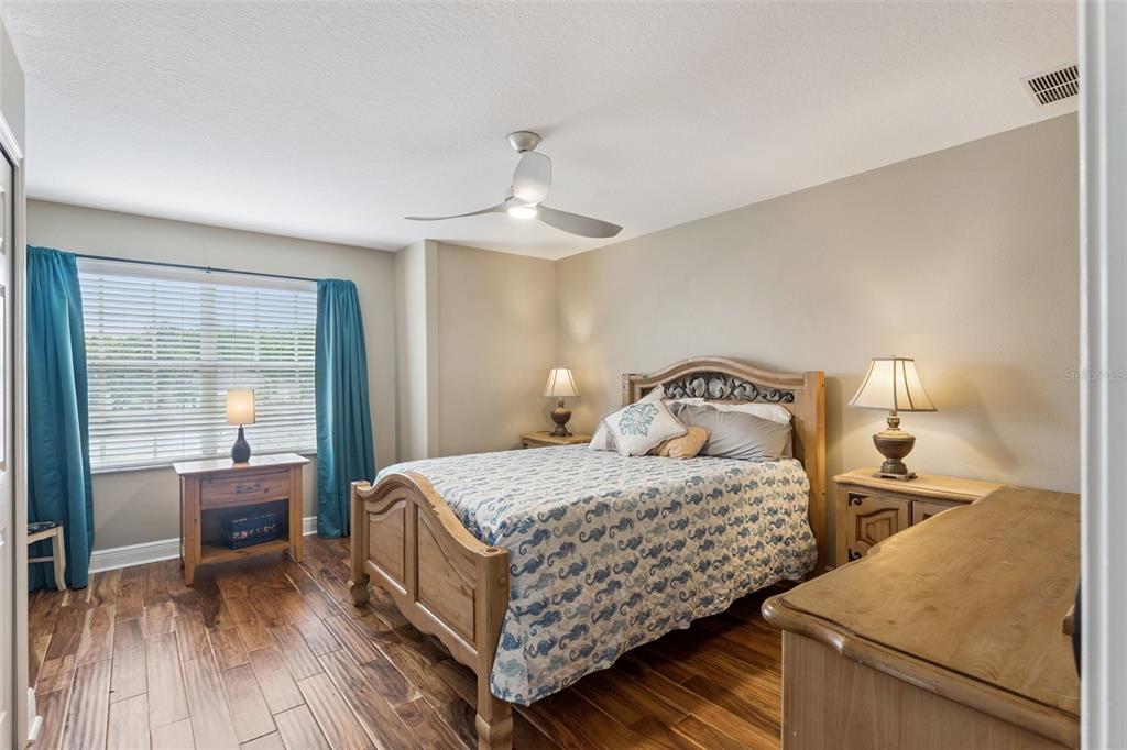 216 Juniper Ridge Court Sanford, FL 32771 - Photo 41 of 61 a bedroom with a bed and wooden floor