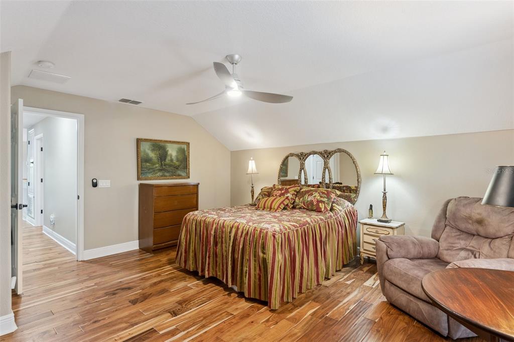 216 Juniper Ridge Court Sanford, FL 32771 - Photo 44 of 61 a bedroom with a bed and a chandelier