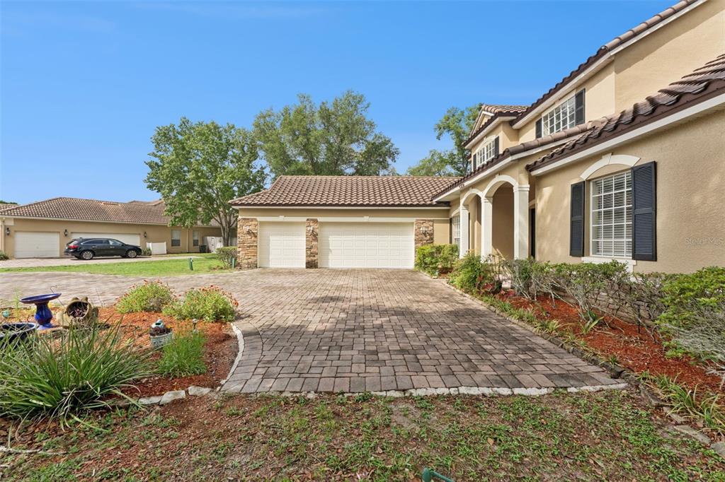 216 Juniper Ridge Court Sanford, FL 32771 - Photo 54 of 61 a front view of a house with a yard and potted plants