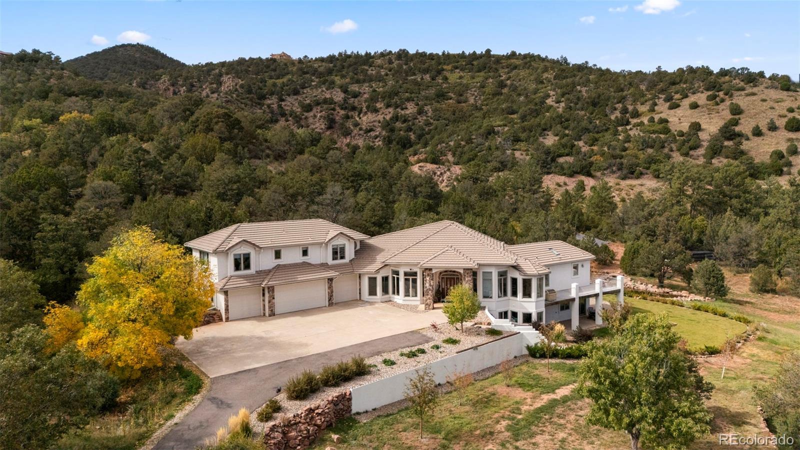 15010 Henry Ride Heights Colorado Springs, CO 80926 - Photo 1 of 50 an aerial view of a house with a big yard