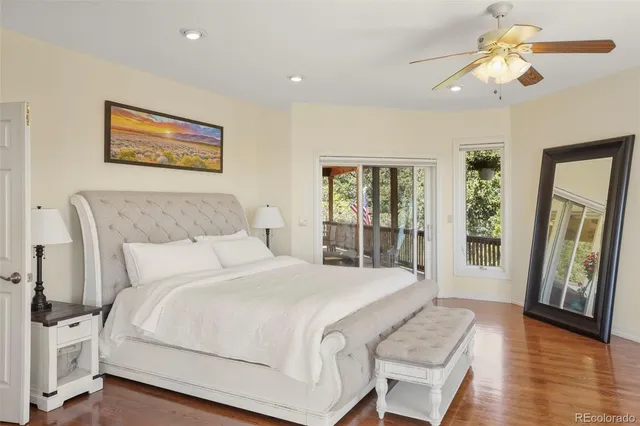 a bedroom with a large bed and a chandelier
