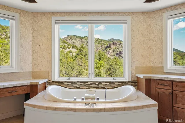 a bath tub sitting in a bathroom next to a window