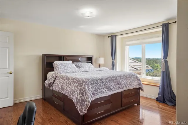 a bedroom with a large bed and a large window