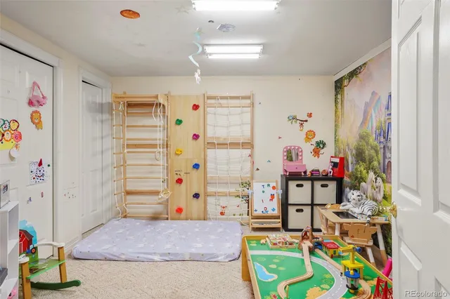 a bedroom with baby toys and wooden floor