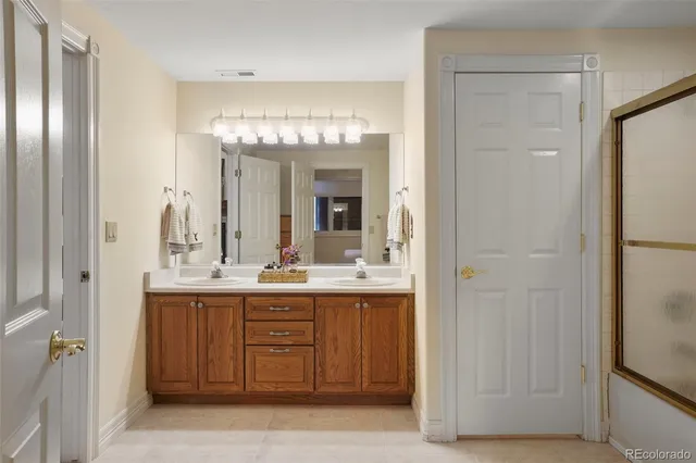 a bathroom with a double vanity sink and a mirror